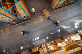 Top Down View: In Warehouse People Working, Forklift Truck Operator Lifts Pallet with Cardboard Box. Logistics, Distribution Center with Products Ready for Global Shipment, Customer Delivery